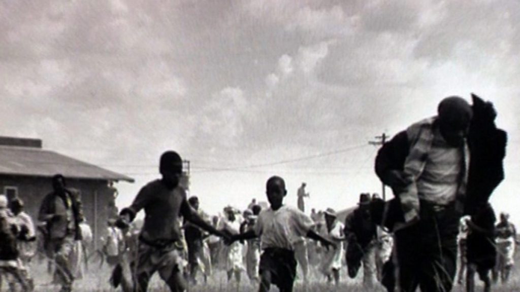 Children and adults running. A still from video 'Sharpeville: A Model Township